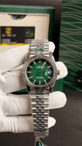 Silver with green Dial.