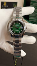 Silver with green Dial.