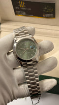 Silver with  green Dial.