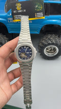 Silver with blue Dial.