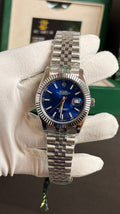 Silver with blue Dial.