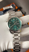 Silver with  green Dial