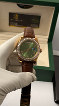 Rose gold with green Dial.