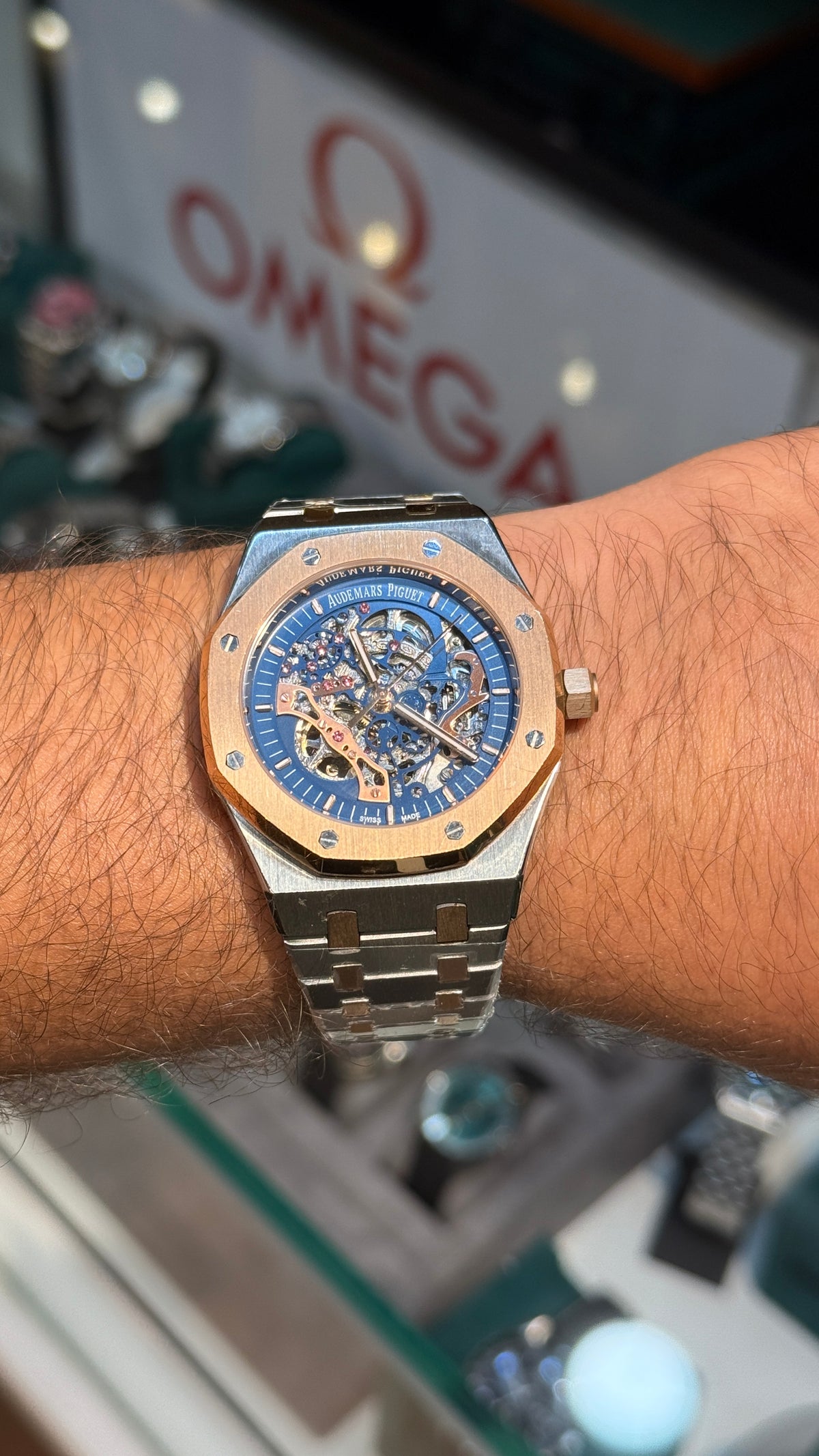 Rose gold two tone with blue skeleton Dial.