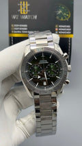 Silver with green Dial.