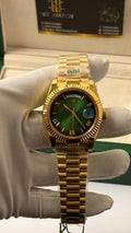 Yellow Gold with  Green Dial.